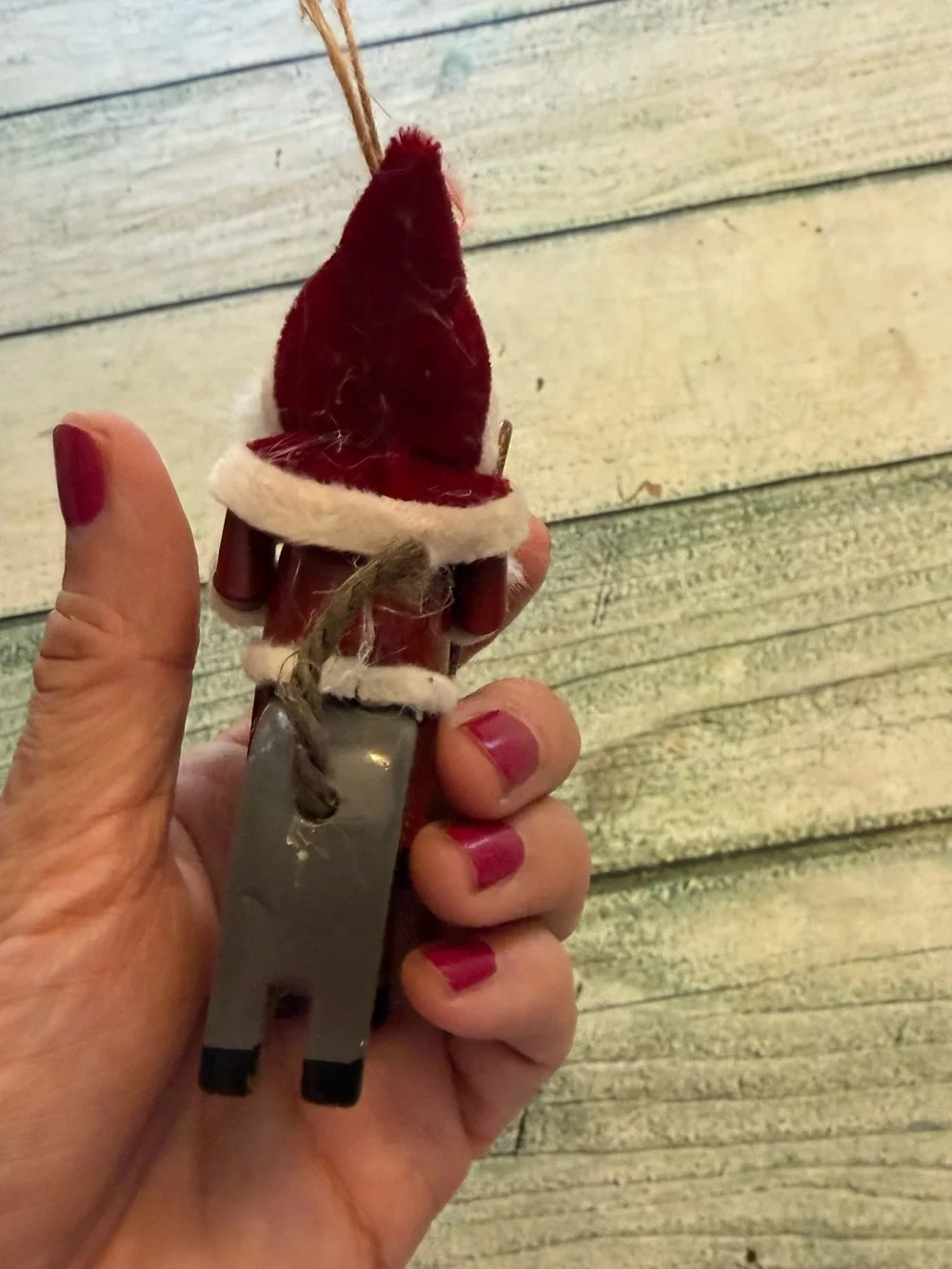 Vintage Christmas wood Santa riding a donkey horse ornament.
